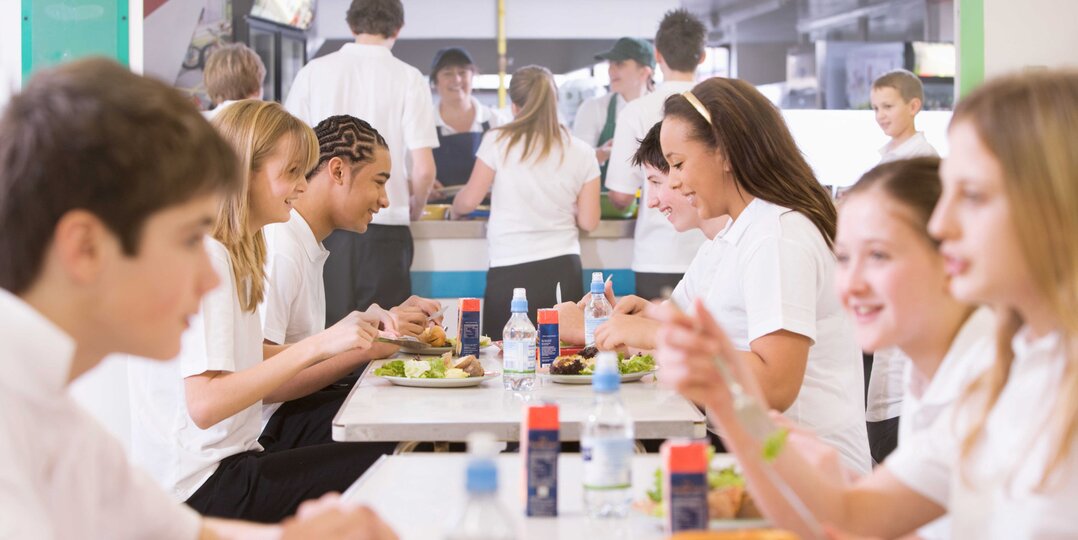 Pupils eat lunch in canteen