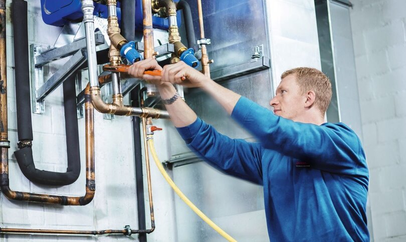 Man repairing refridgeration system pipe